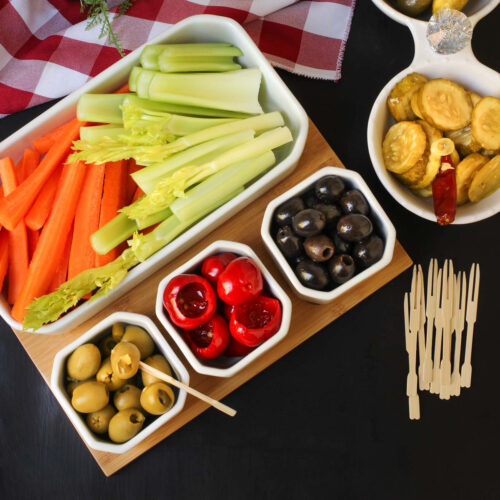 overhead shot of the relish tray near a stack of toothpicks on a holiday table.