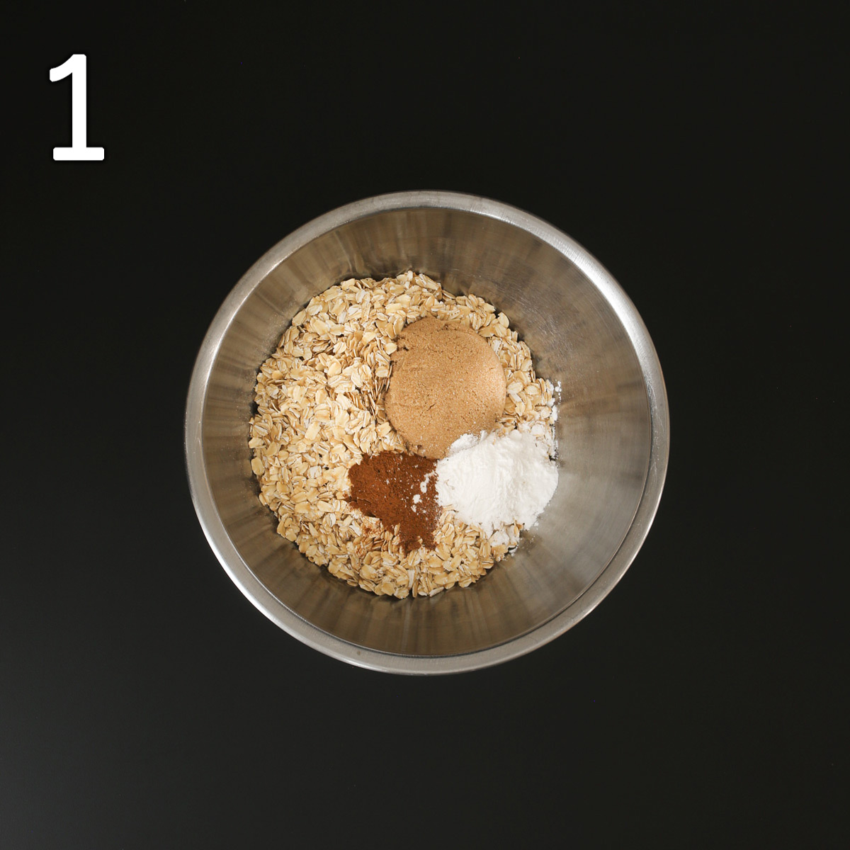 oats, leaveners, sugar, and spices in a steel mixing bowl.