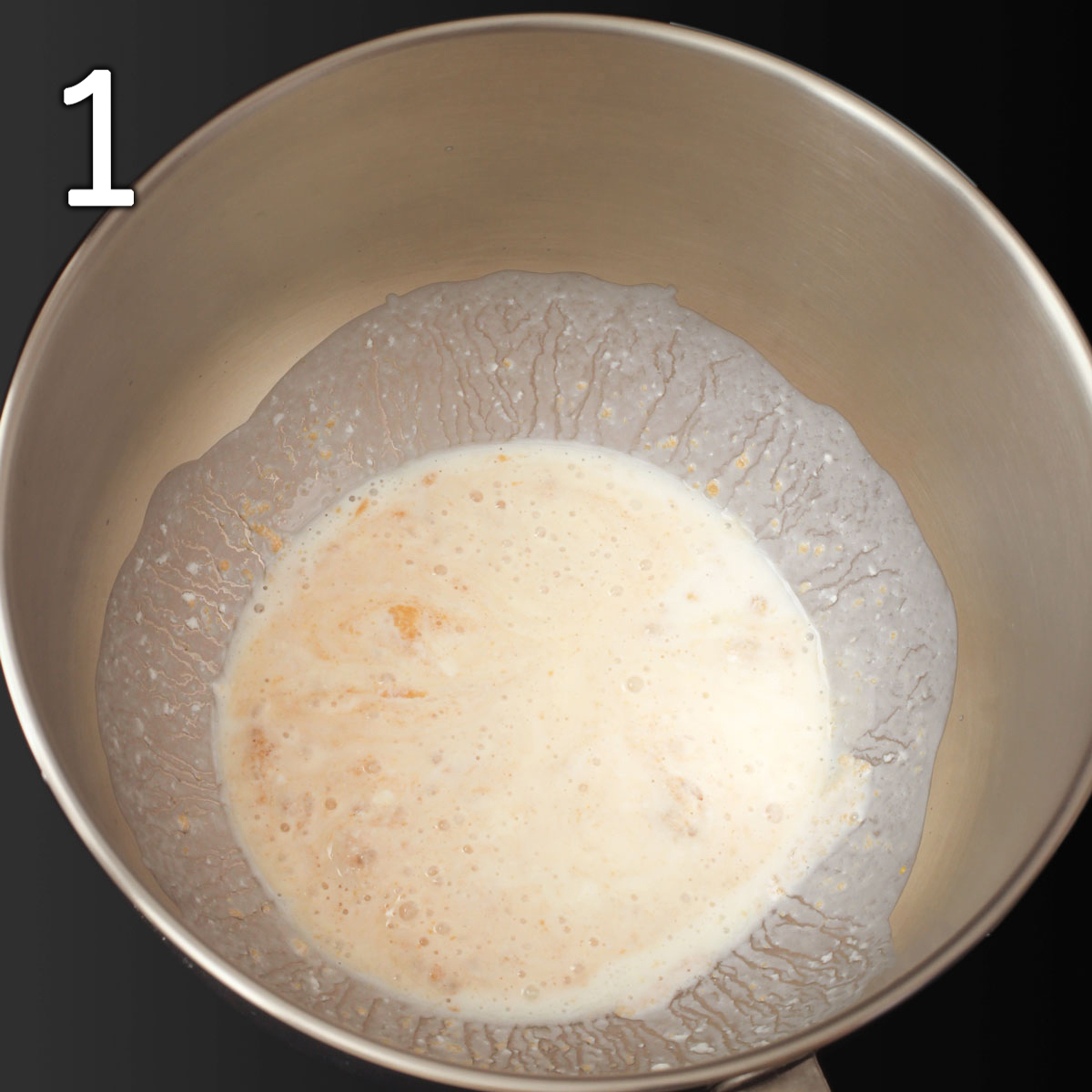 yeast proofing with milk and sugar in mixing bowl.