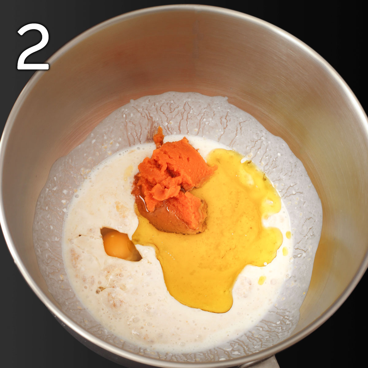 adding egg, pumpkin, and oil to yeast mixture in mixer bowl.