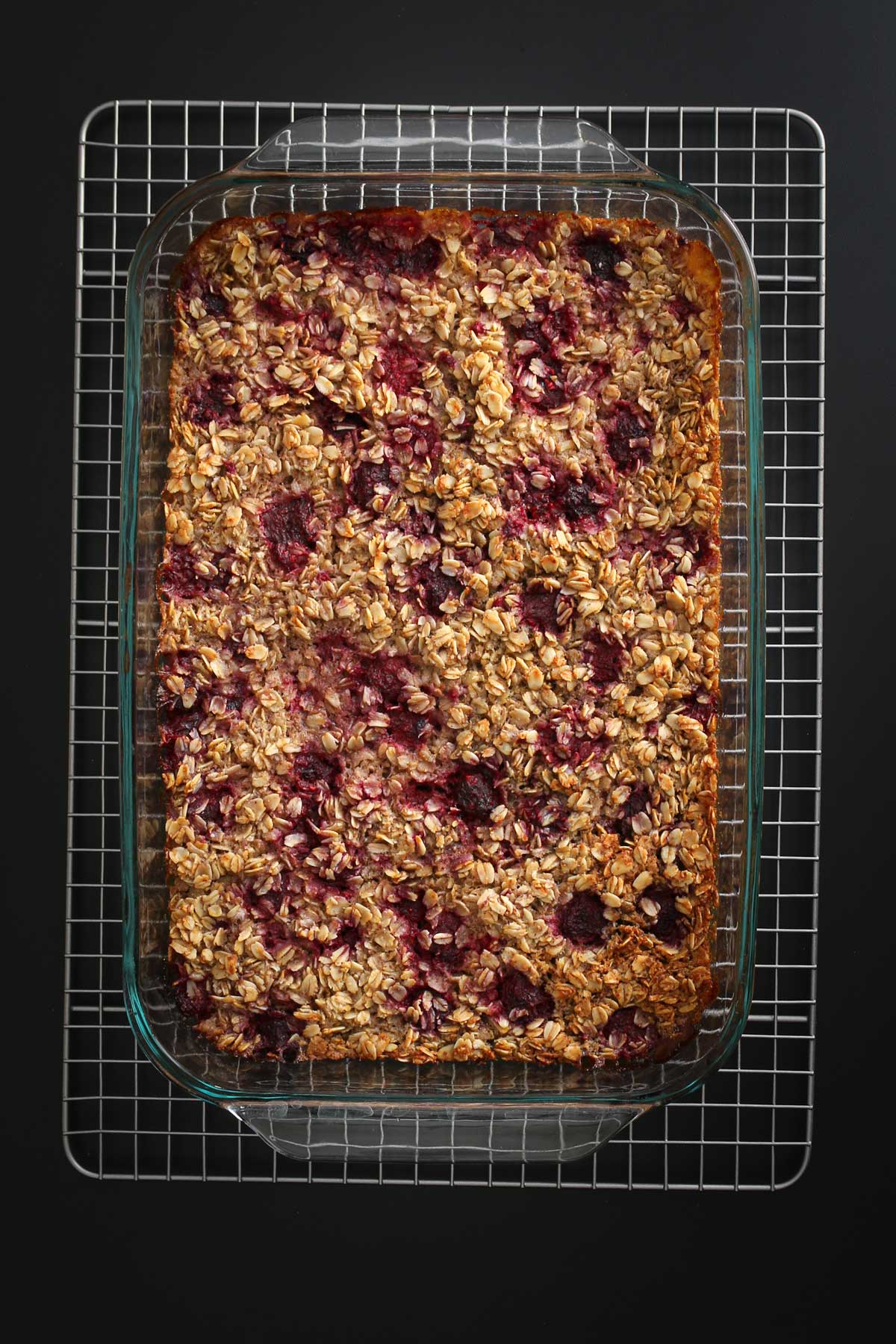 vegan baked oatmeal cooling on wire rack in its pan.