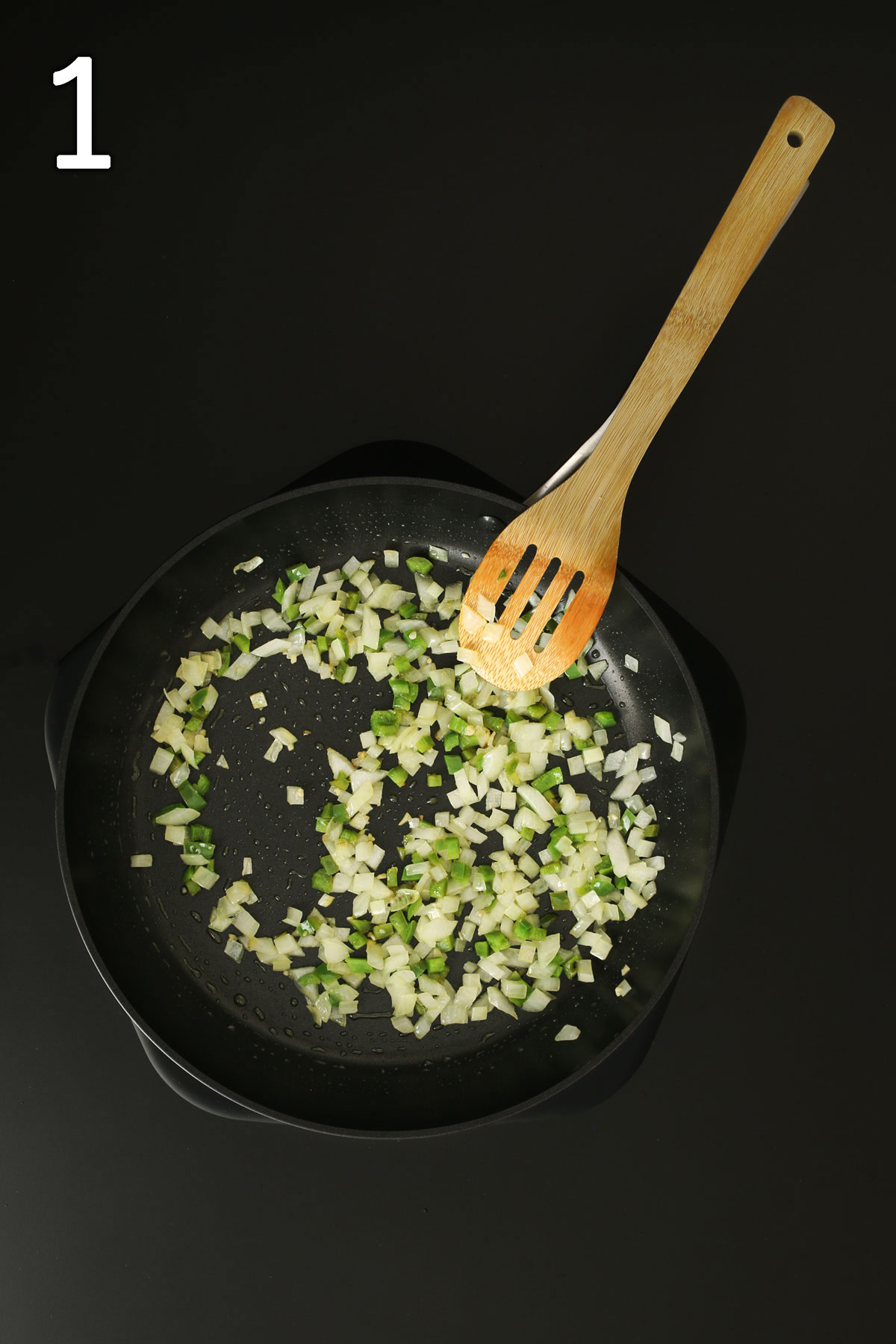 sauteing onions, garlic, and jalapeno in large skillet with wooden spoon.