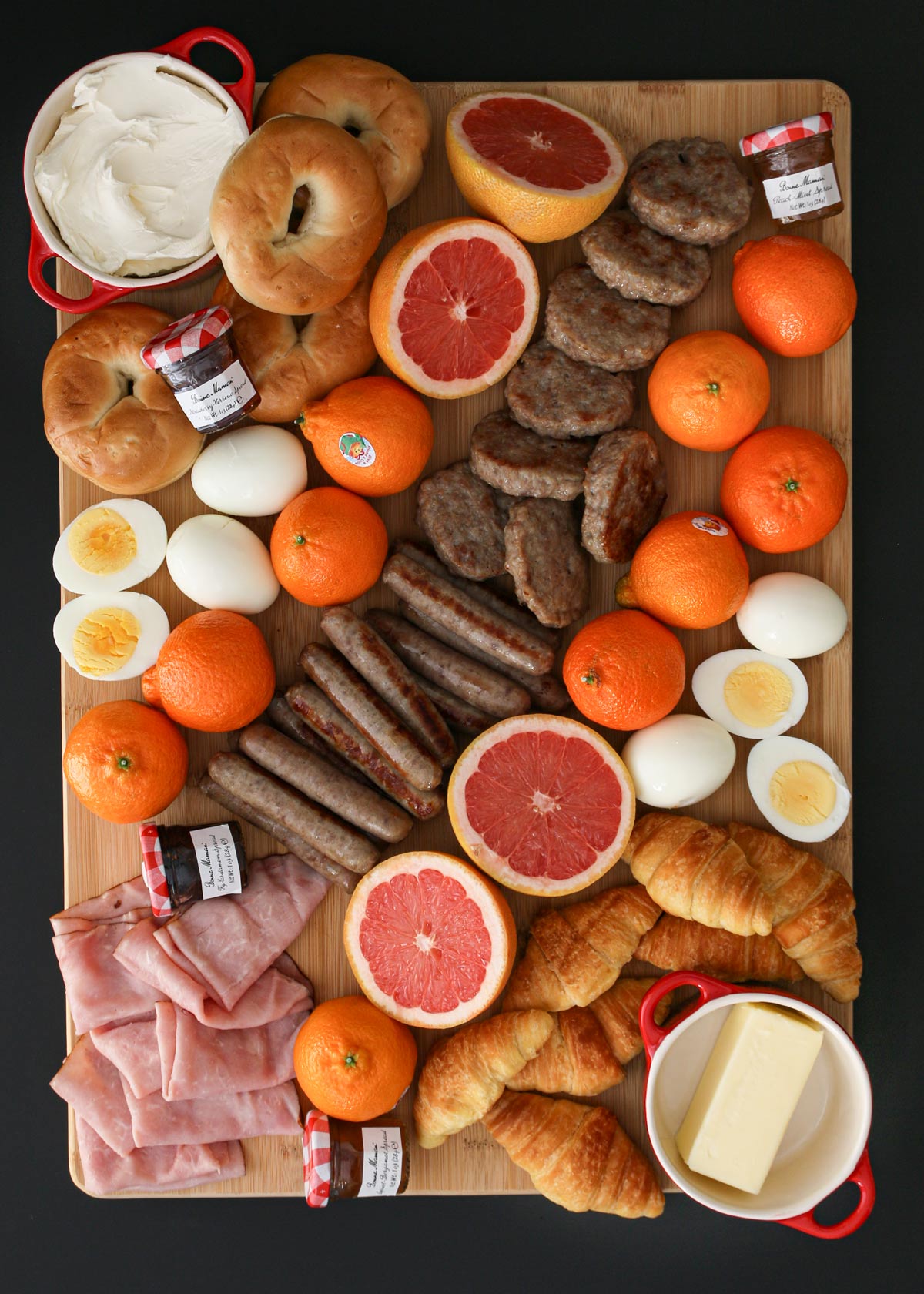 overhead shot of large breakfast charcuterie board on black table.