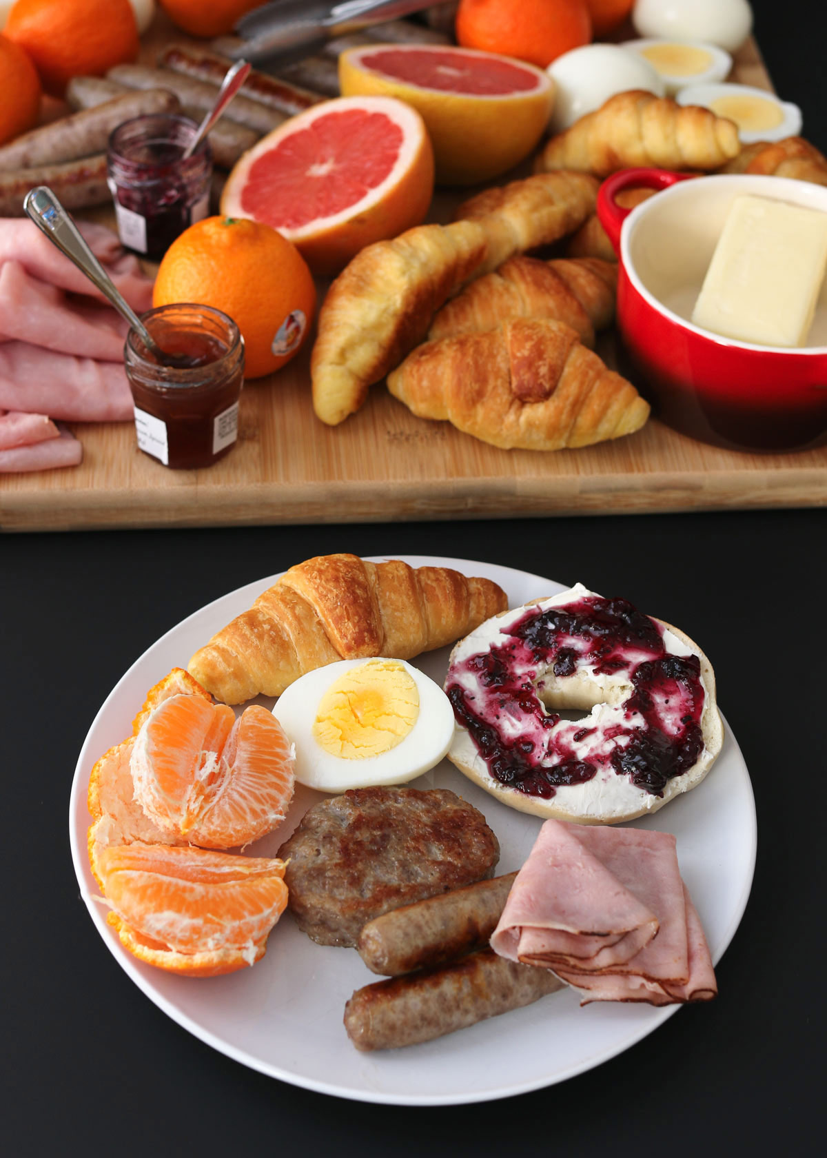 breakfast plate on table near larger breakfast charcuterie board.