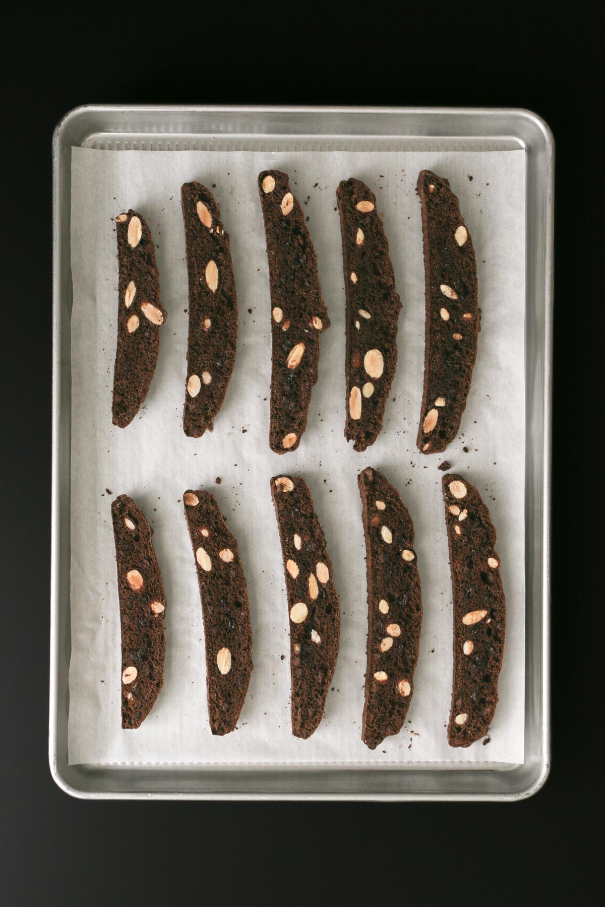 biscotti flipped on parchment on baking sheet.