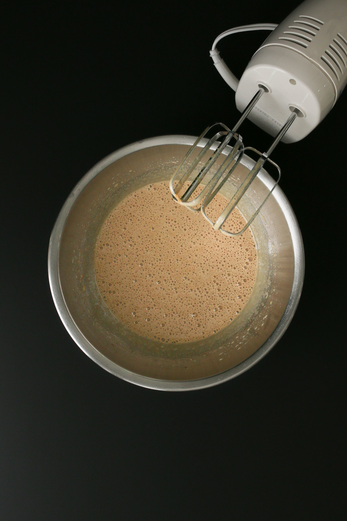 frothy egg and sugar mixture in a bowl.