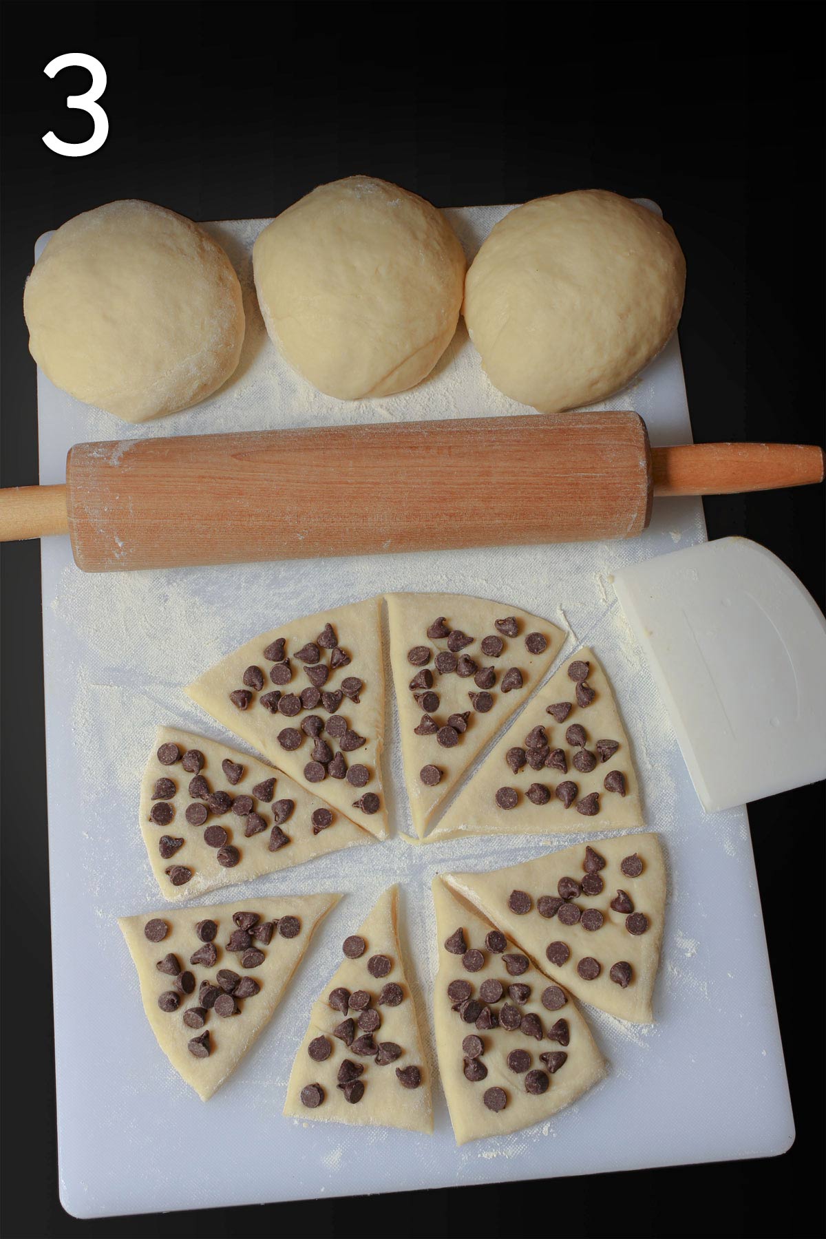 chocolate chips laid out on each of the wedges of dough.