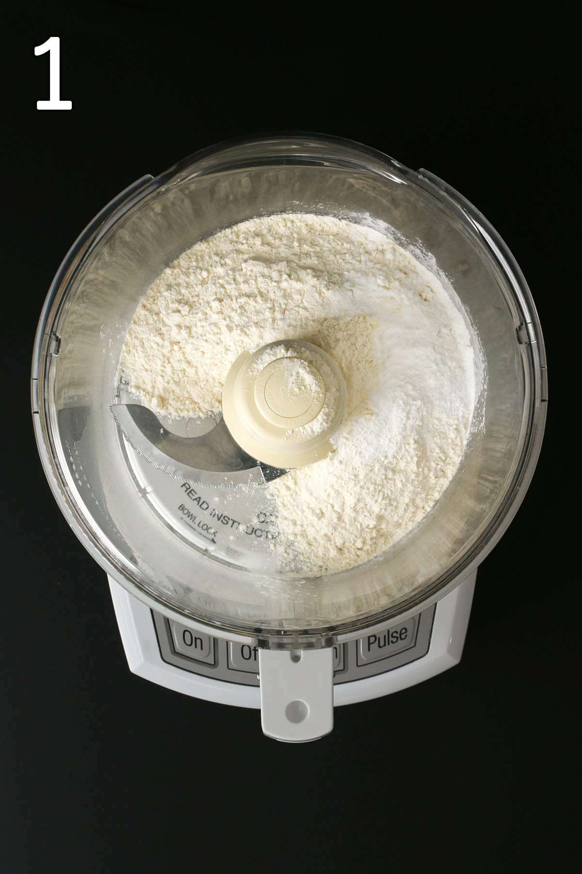 flour, baking powder, and salt in food processor bowl fitted with a metal blade.