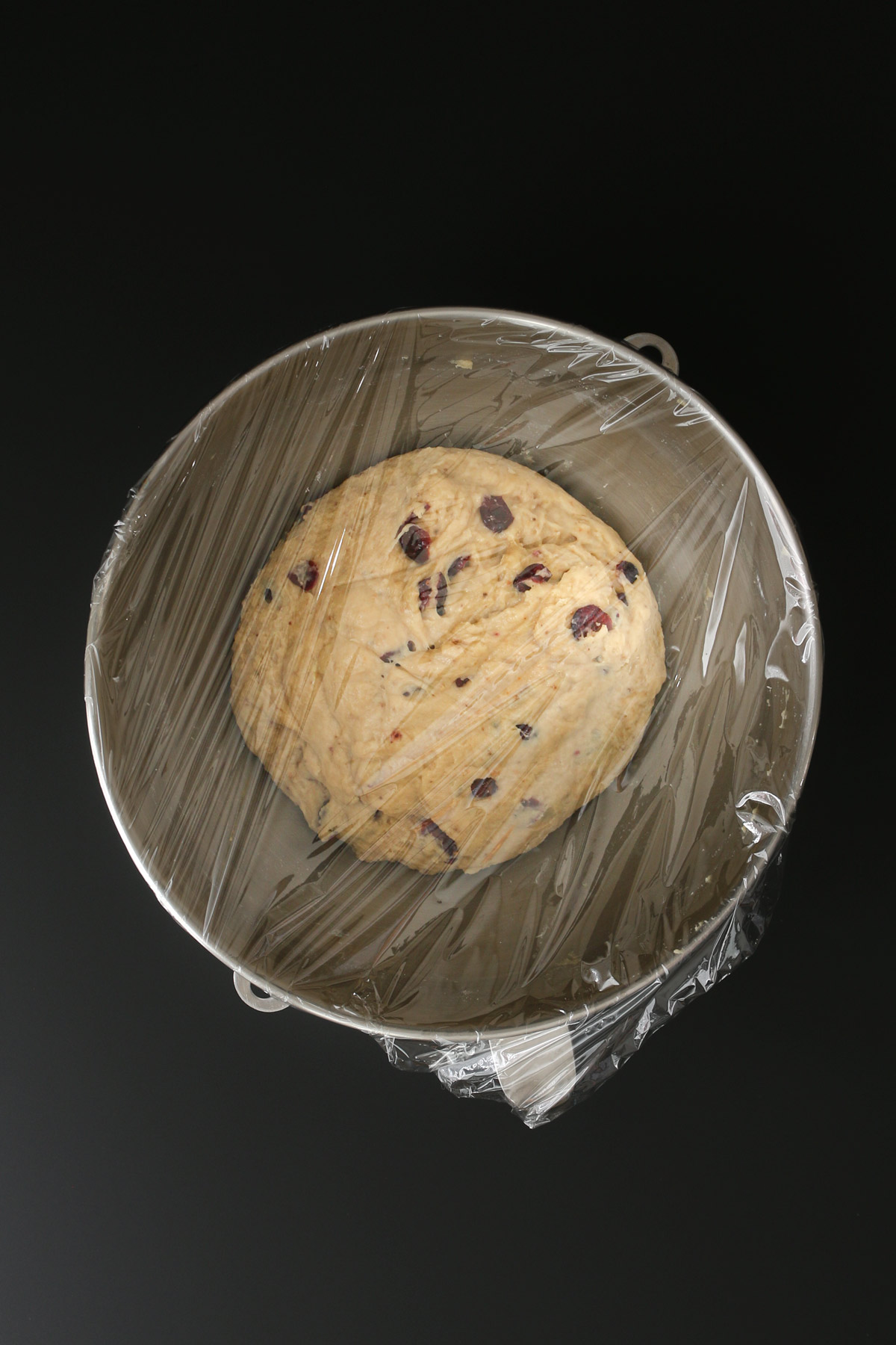 the mixer bowl covered with plastic wrap for the dough to rise.