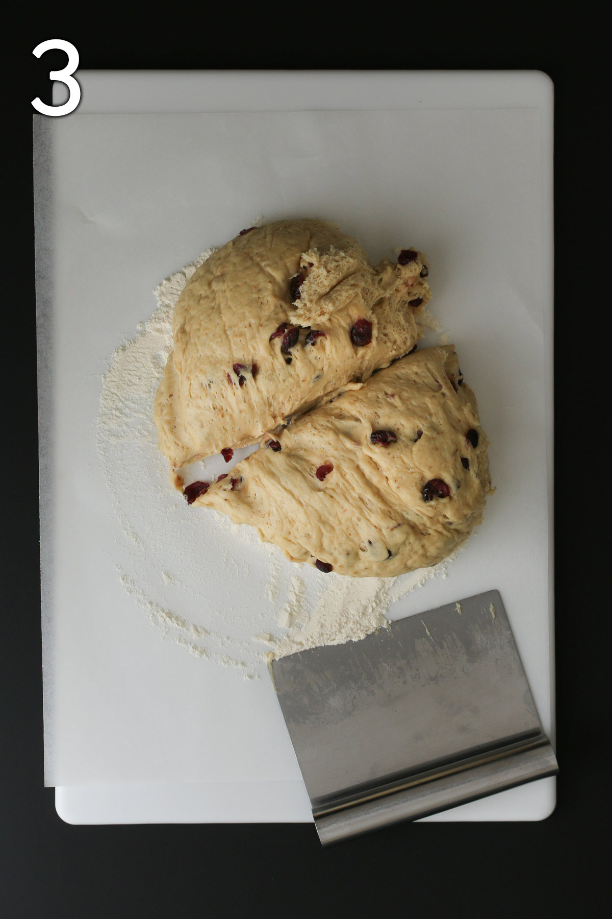 the dough ball transferred to a floured board and cut in half with a metal bench knife.