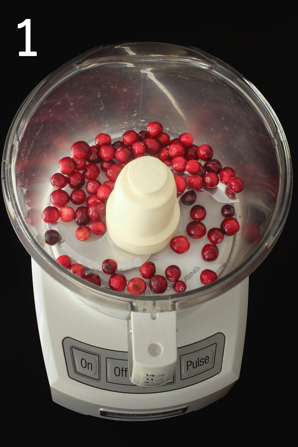 cranberries in food processor fitted with metal blade.