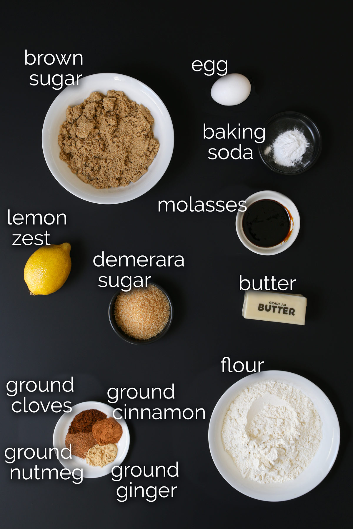 ingredients for molasses crinkles measured and laid out on the table top.