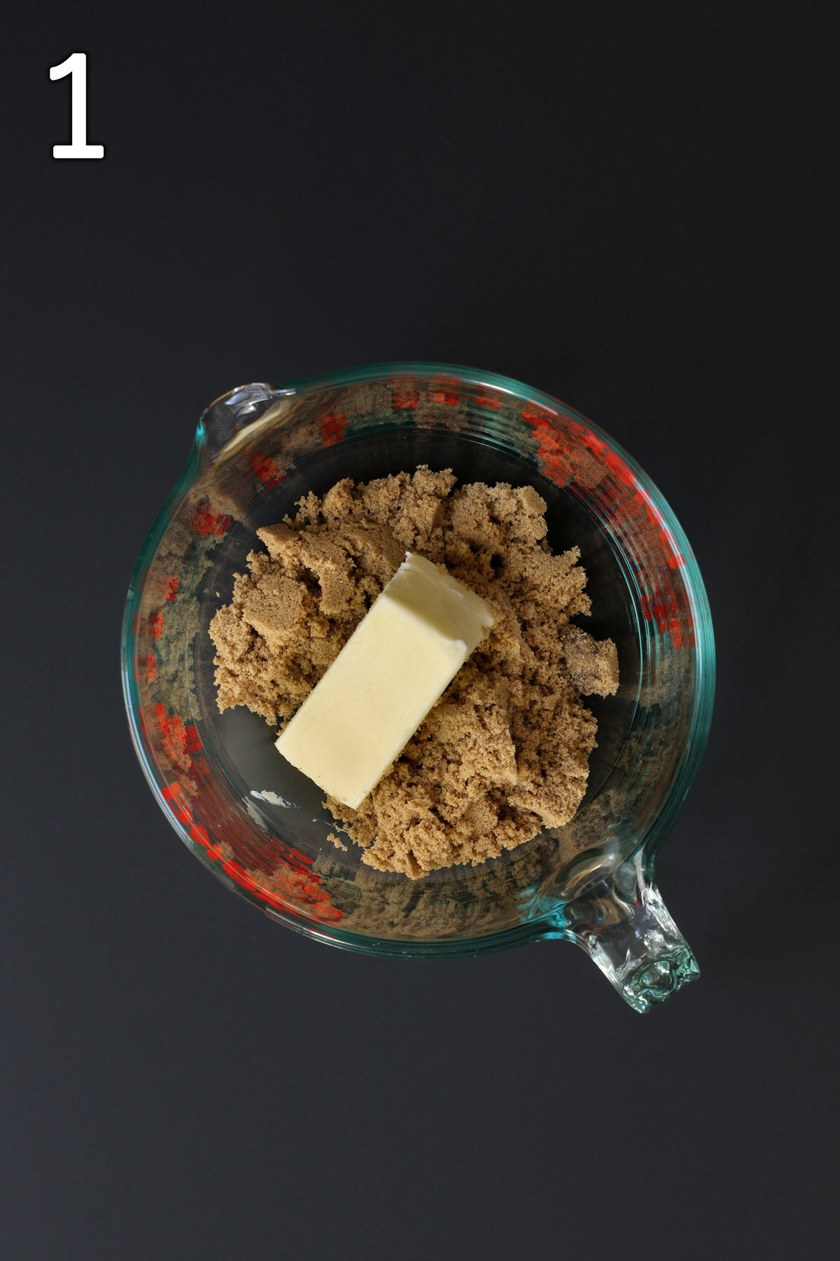 brown sugar and stick of softened butter in glass pyrex bowl.