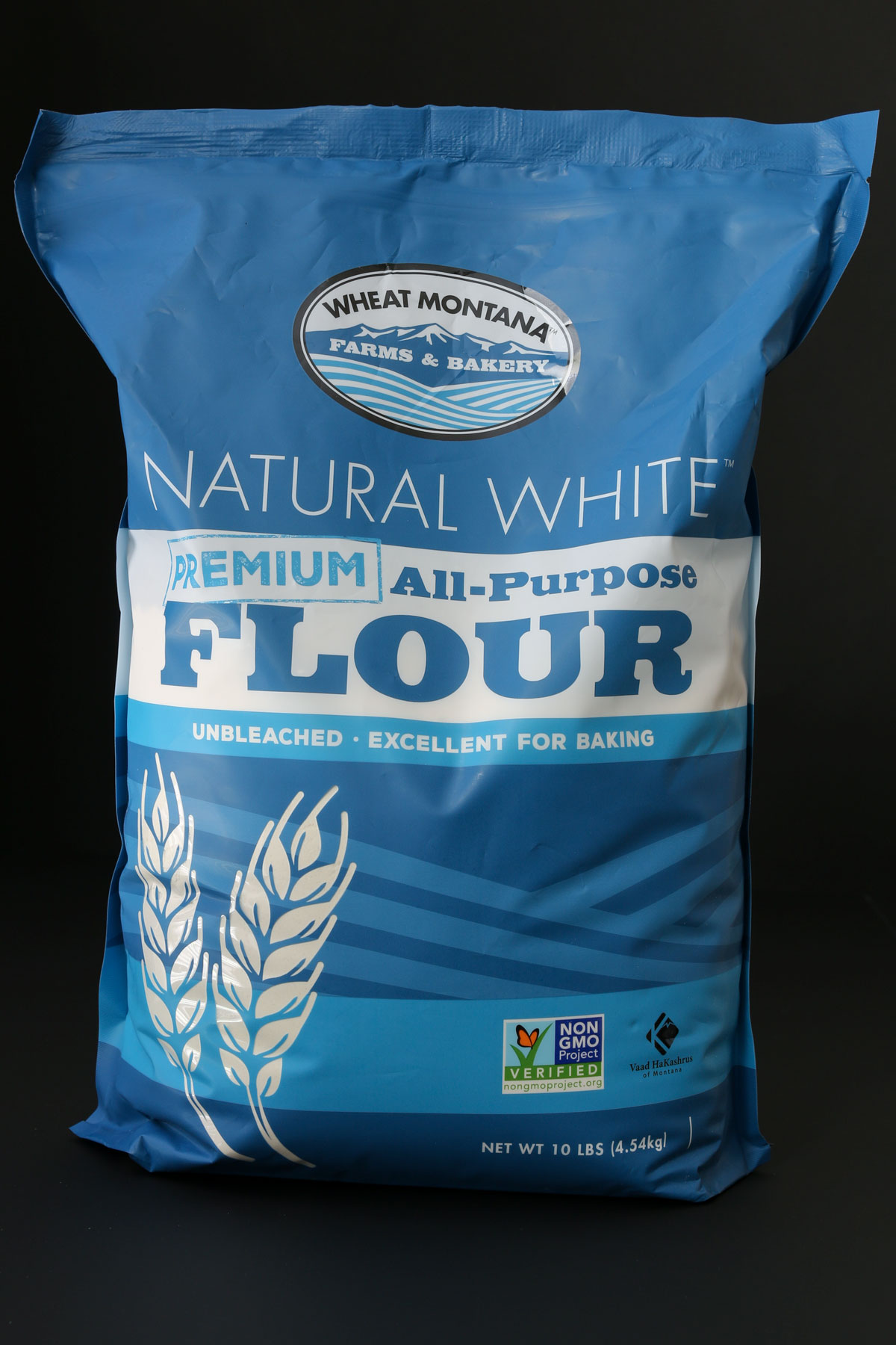 brand new bag of flour on black table.