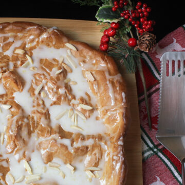 oslo kringle pastry on a serving board with holiday decor nearby.