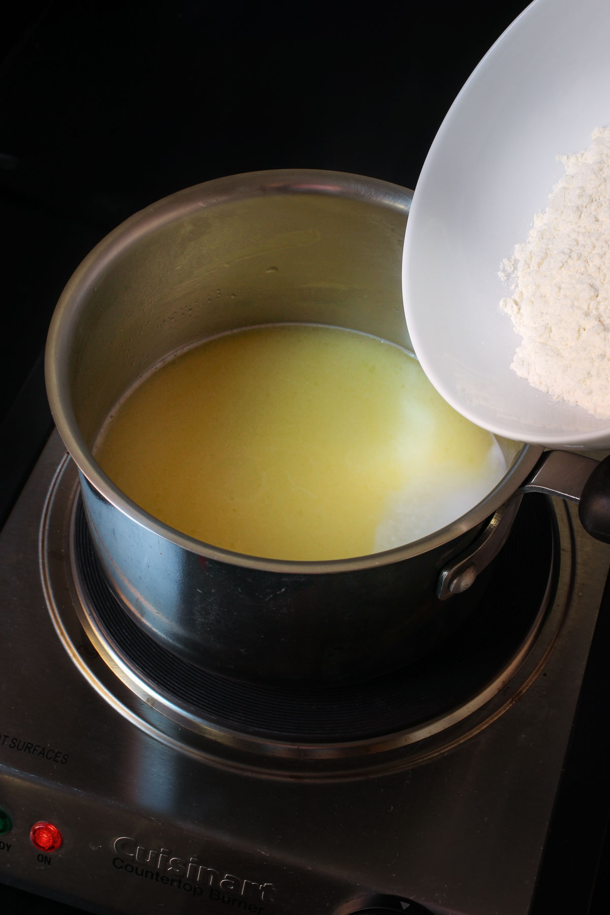 water added to the butter and now flour in a bowl to add.