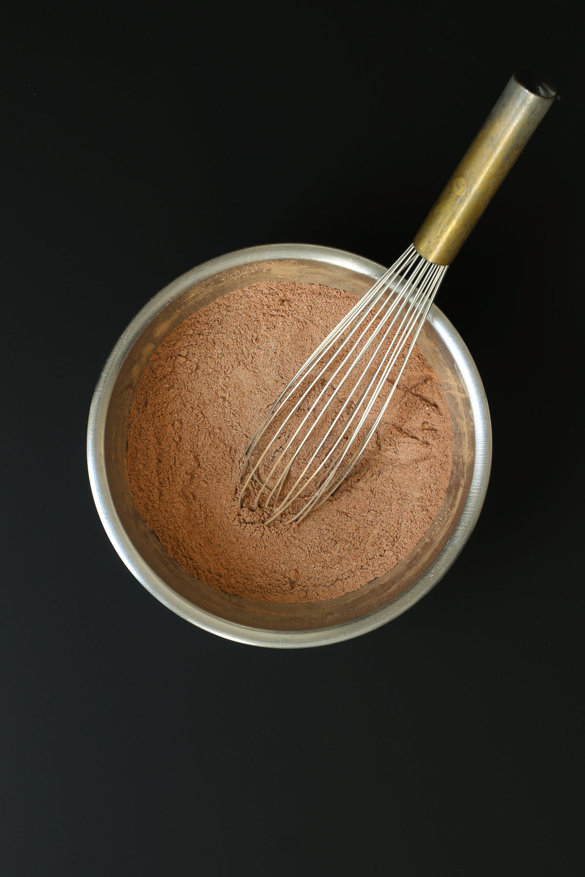 brownie ingredients whisked together in a steel mixing bowl.