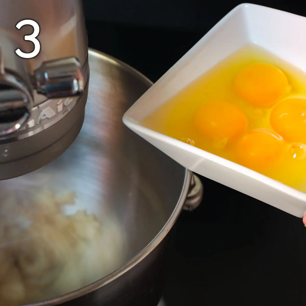 adding eggs to the mixture in the stand mixer.