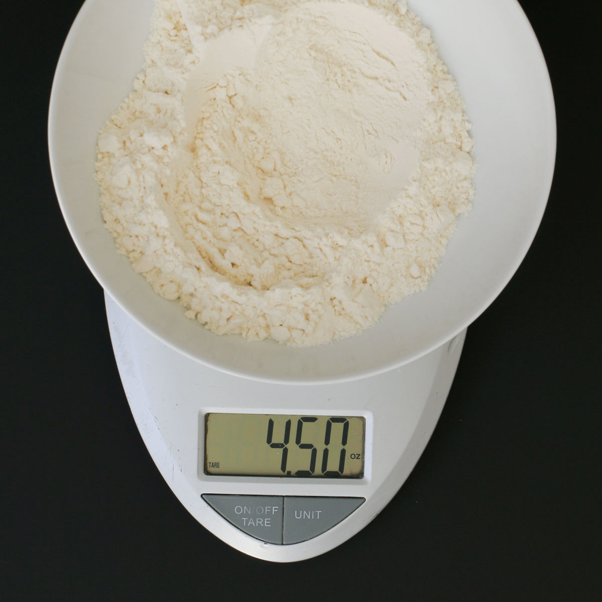 Measuring Flour Into Kitchen Scales Stock Photo, Picture and