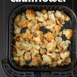 cauliflower in the air fryer basket with text overlay.