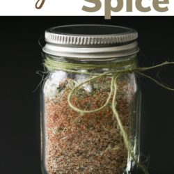 jar of cajun spice mix with a black background with text overlay.