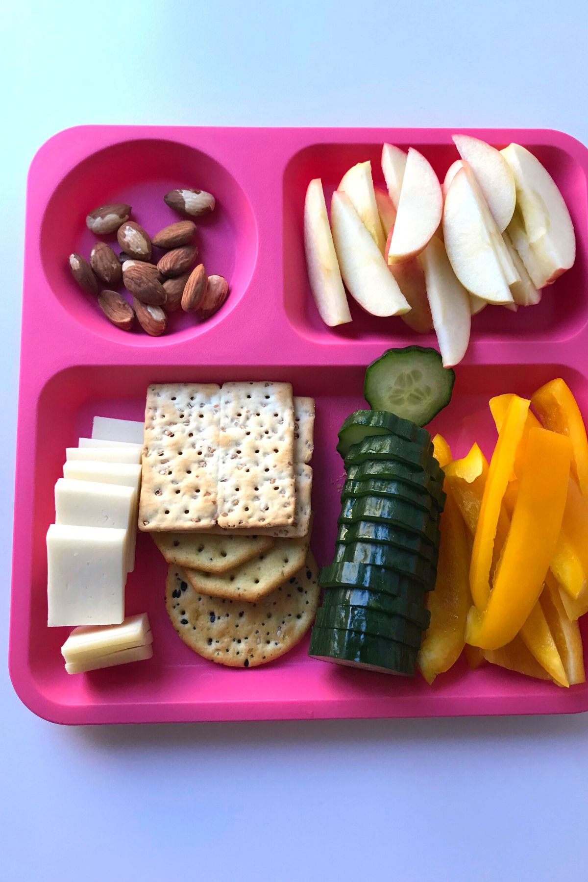 snack foods on a pink divided tray.