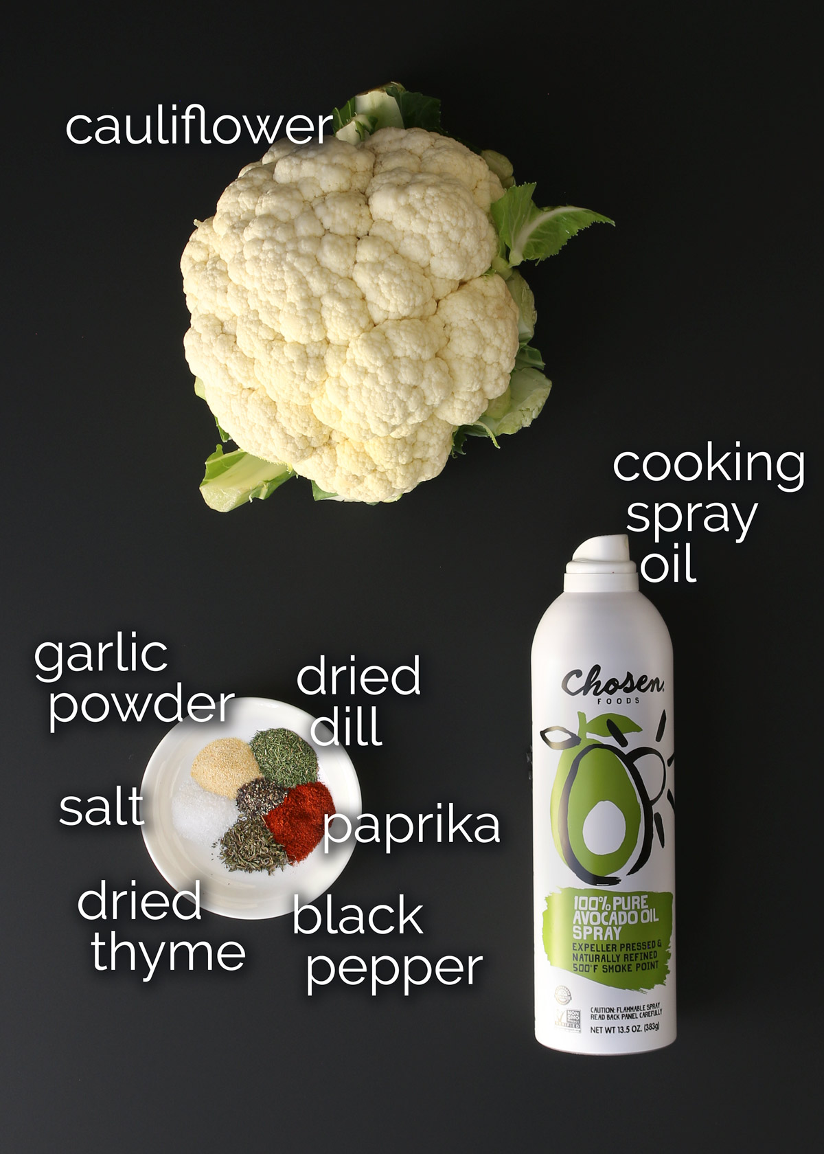 ingredients for air fryer cauliflower laid out on a black table.