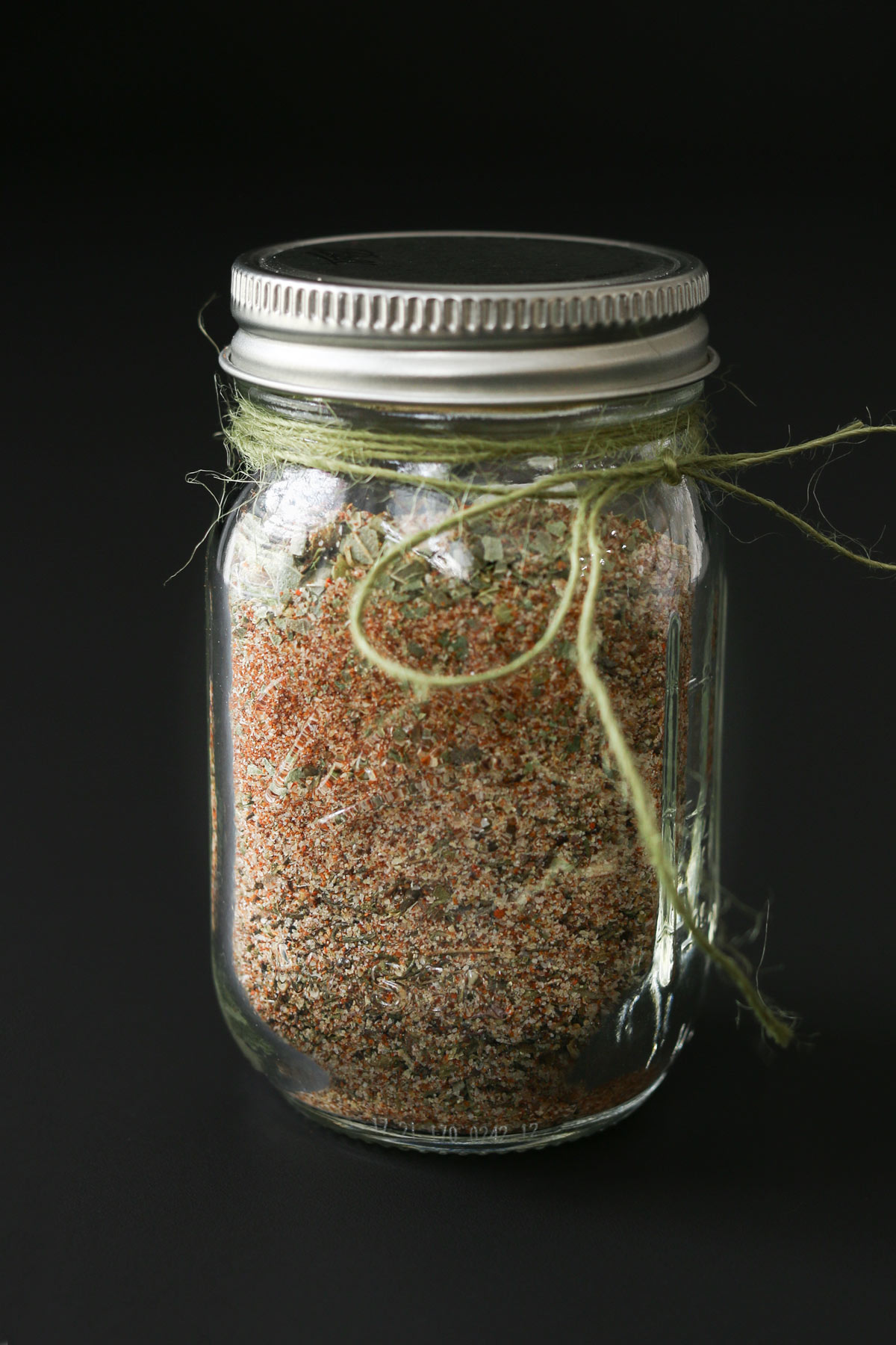 jar of cajun spice blend with green baker's twine around the top.