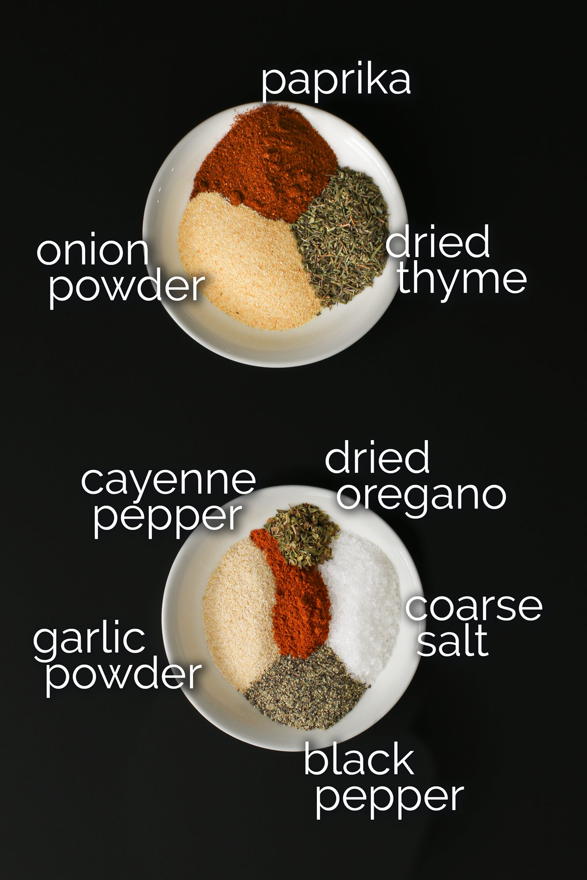 spices measured into white dishes to make cajun spice blend.