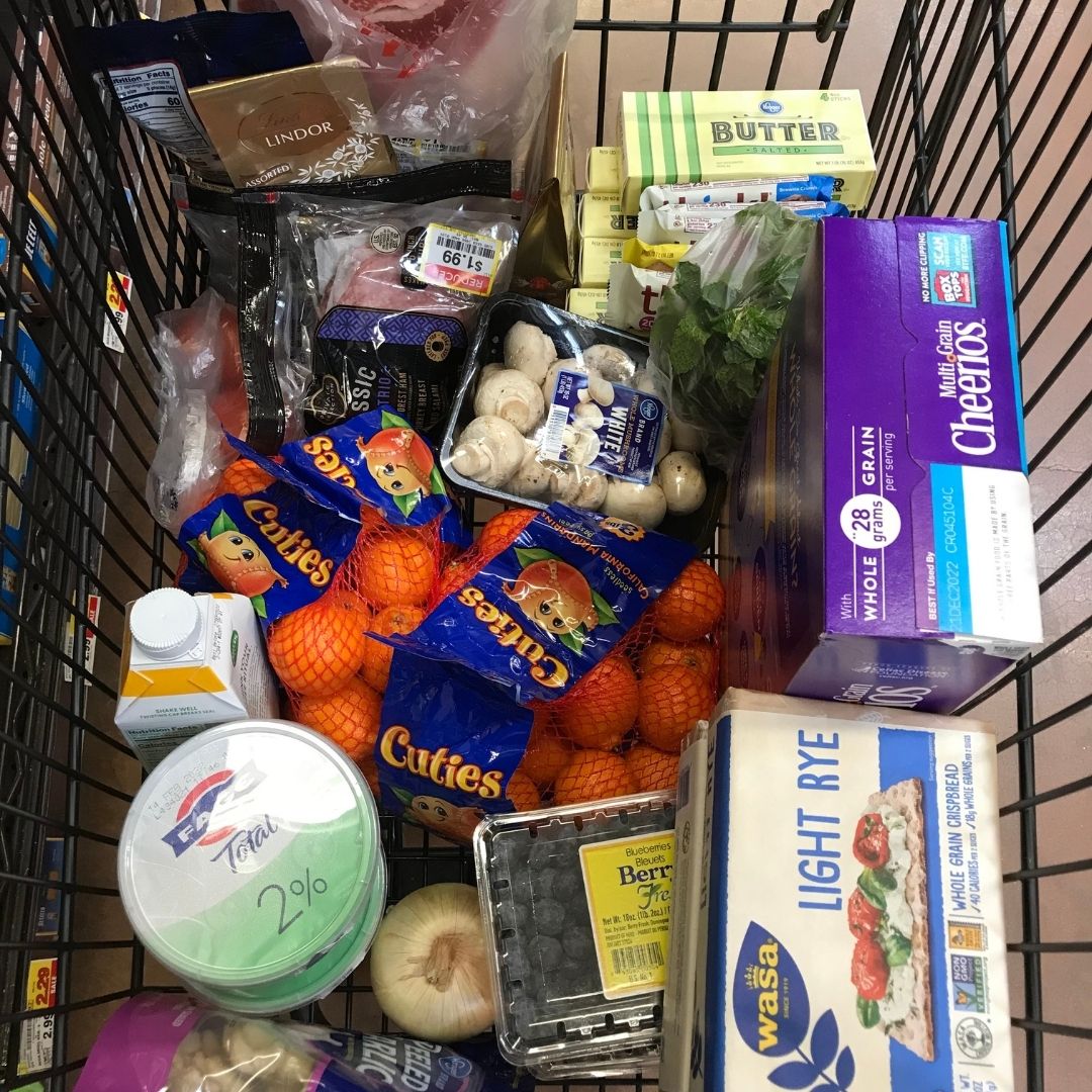 grocery cart full of groceries.