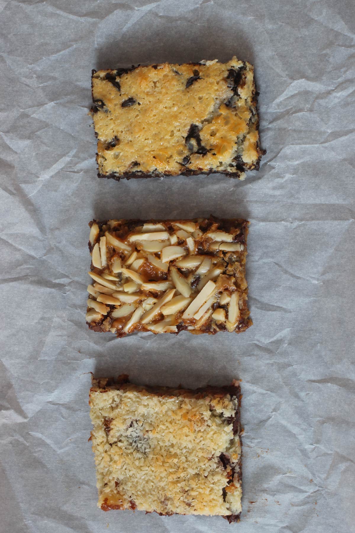 three different 7 layer bars laid out on parchment.