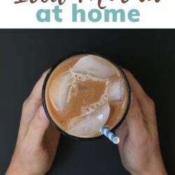 hands holding an iced mocha with a blue straw, with text overlay.
