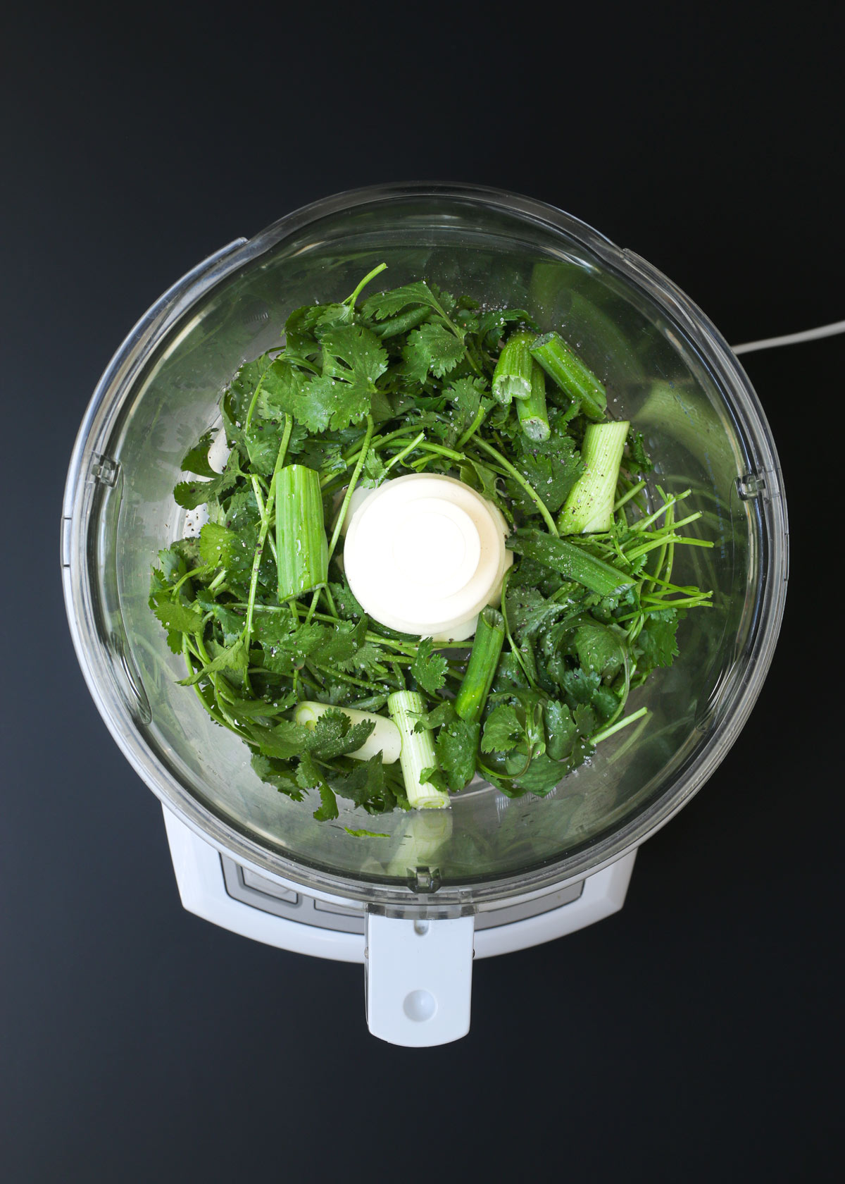 cilantro, green onion, and lime juice in food processor fitted with a metal blade.