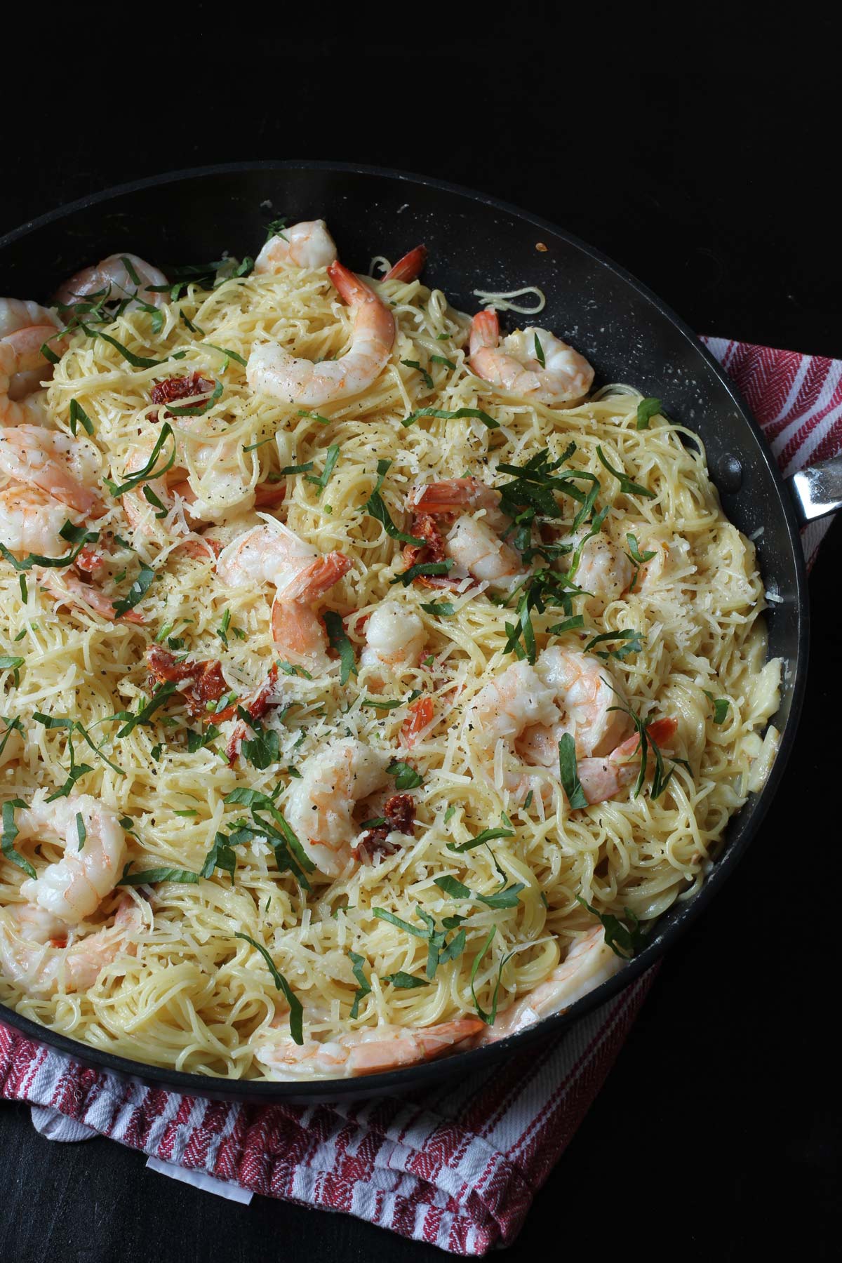 close up of creamy shrimp pasta in skillet.