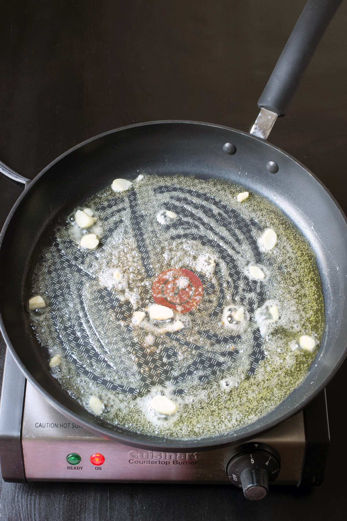 cooking garlic in melted butter in skillet.