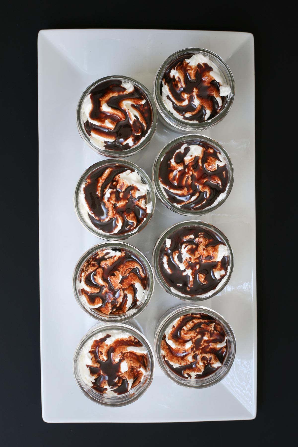 array of 8 chocolate parfait on a white tray.