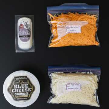 goat cheese, cheddar, blue cheese, and a bag of jack cheese ready for freezing.