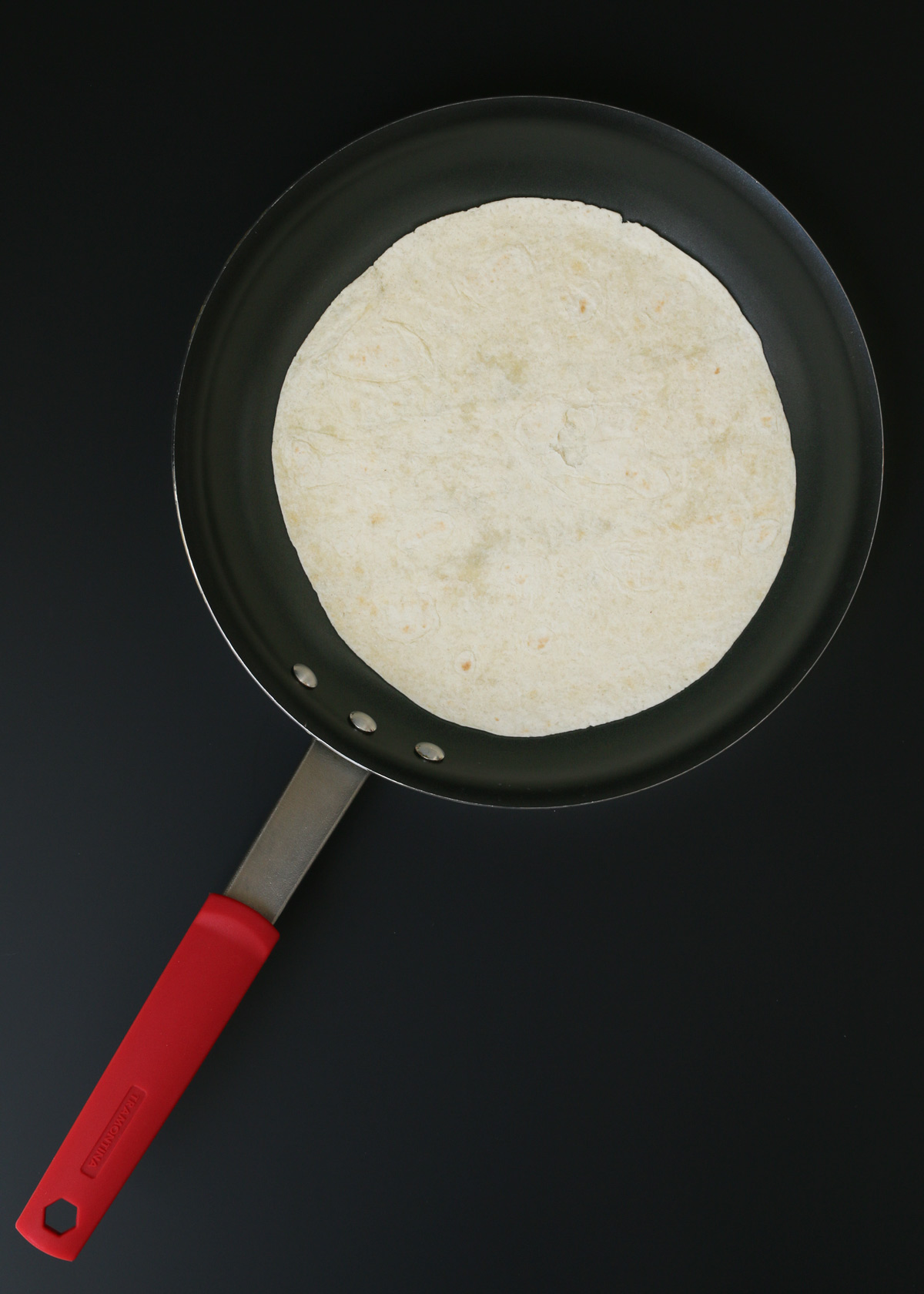 plain tortilla in skillet.