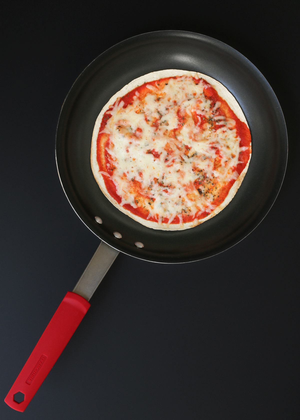 cooked pizza in skillet.