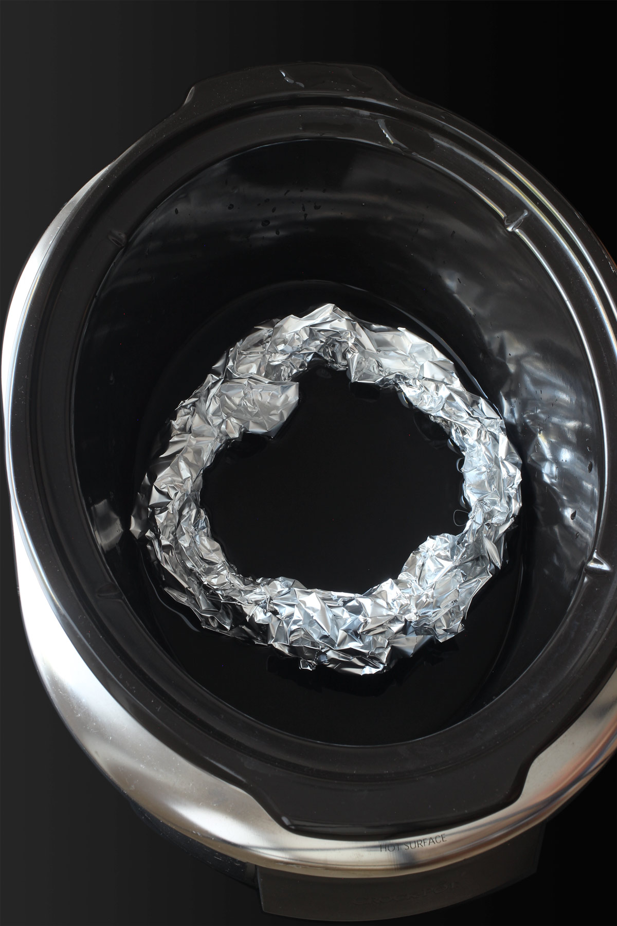 coil of foil in bottom of slow cooker with water.