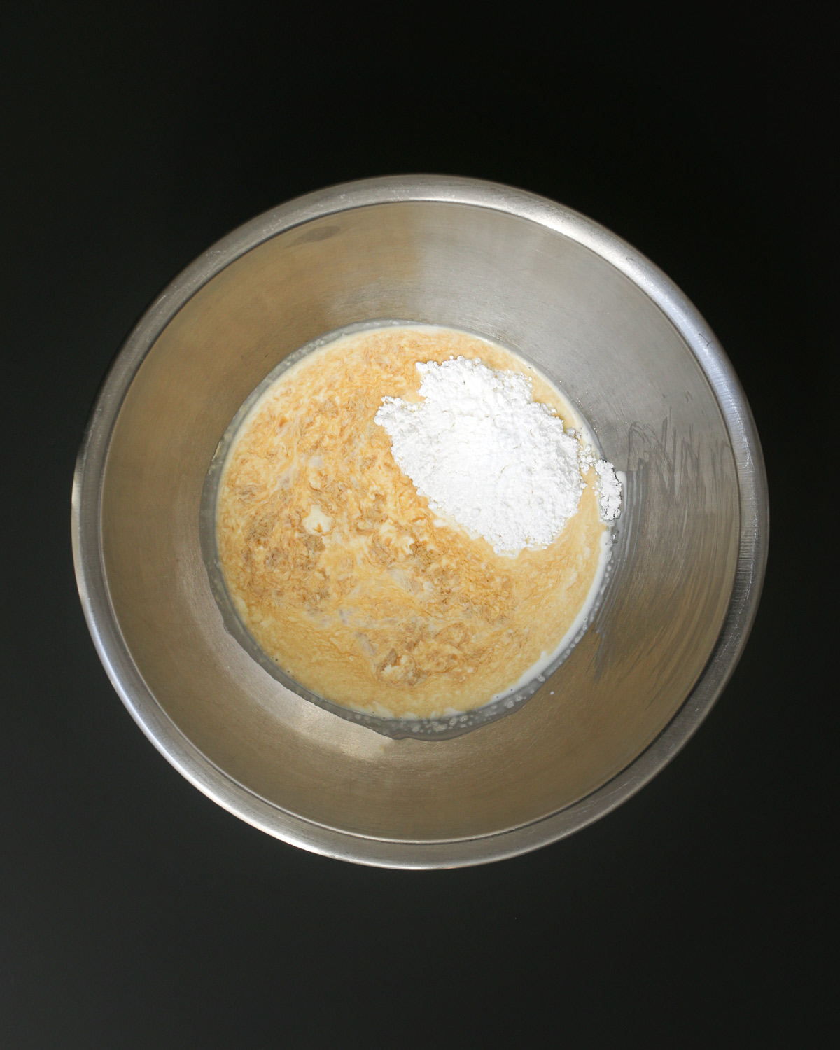 sugar, cream, and vanilla extract in metal mixing bowl.