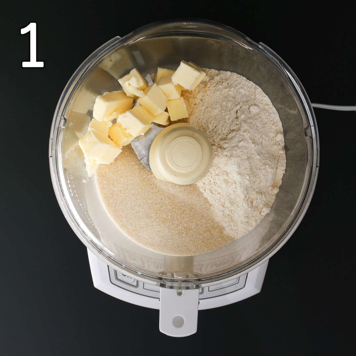 butter, flour, and sugar in bowl of food processor.