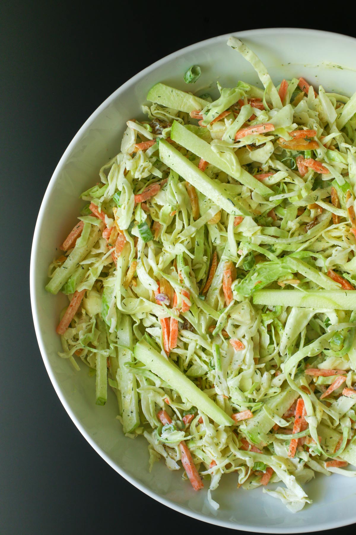 overhead close-up of coleslaw with julienned apple.