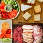 meat and cheese platters on buffet table.