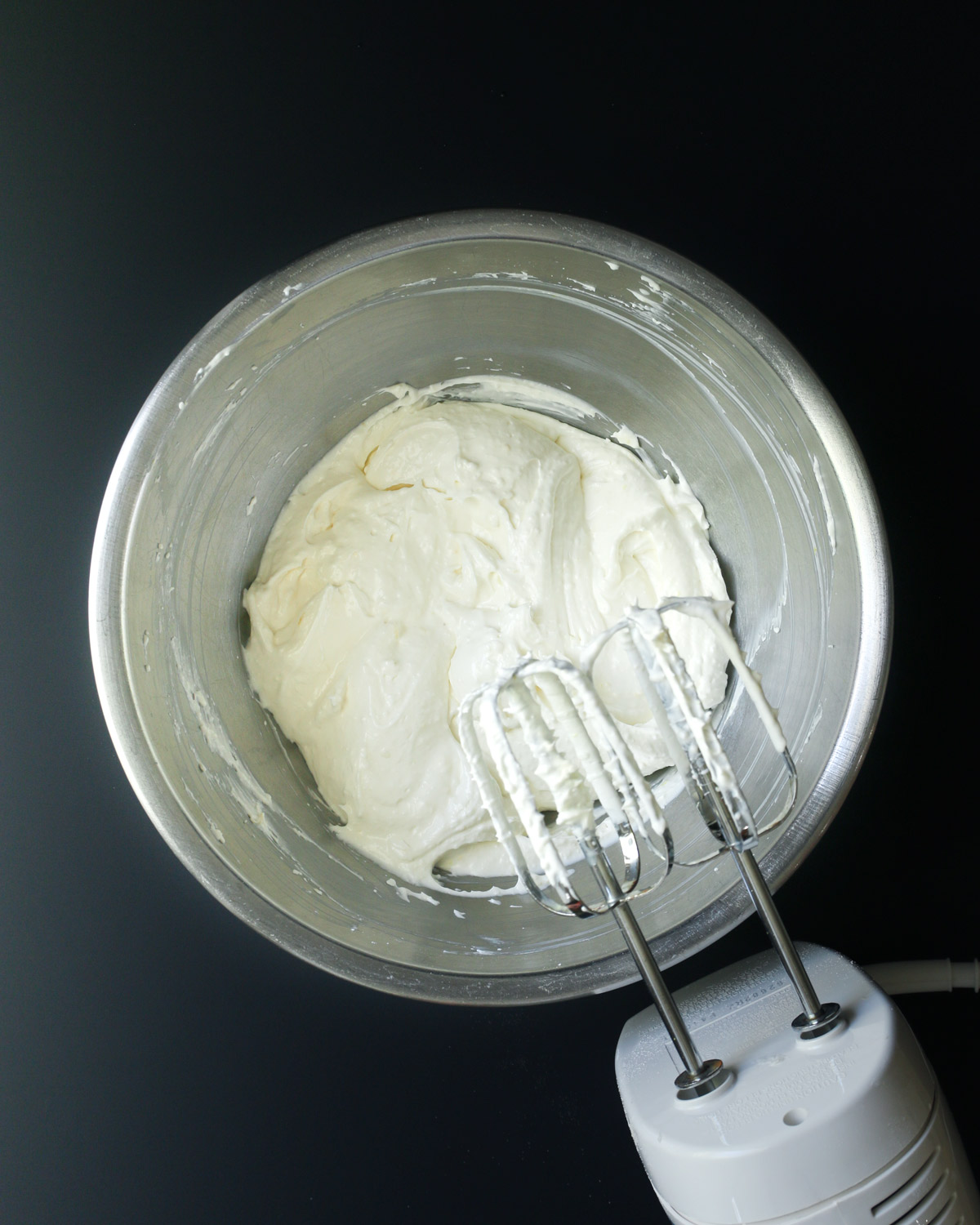 whipped mixture in mixing bowl and hand mixer.