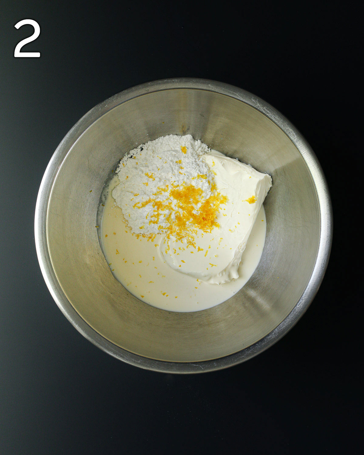 cream cheese, whipping cream, sugar, and lemon zest in mixing bowl.