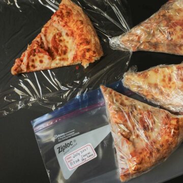pizza wrapped in plastic for freezing.
