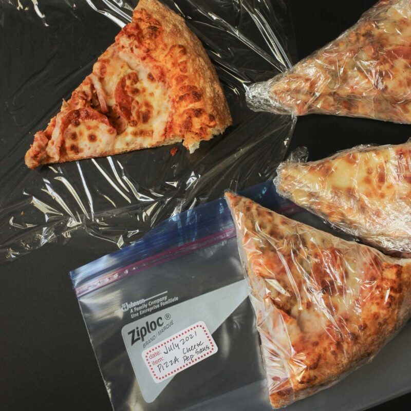 pizza wrapped in plastic for freezing.