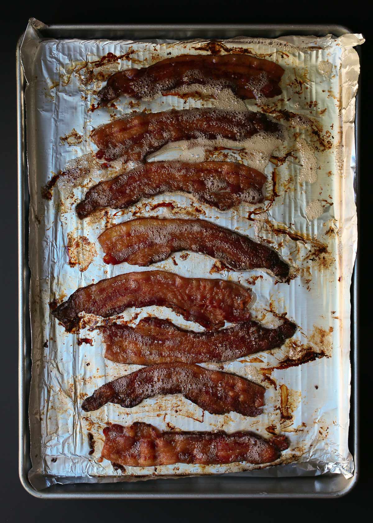 cooked bacon on rimmed and lined baking sheet.