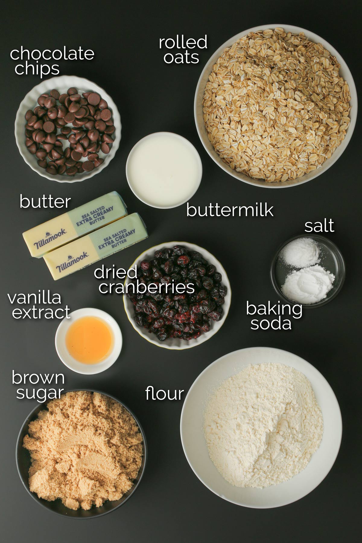 ingredients for Oatmeal Craisin Cookies laid out on a black table.